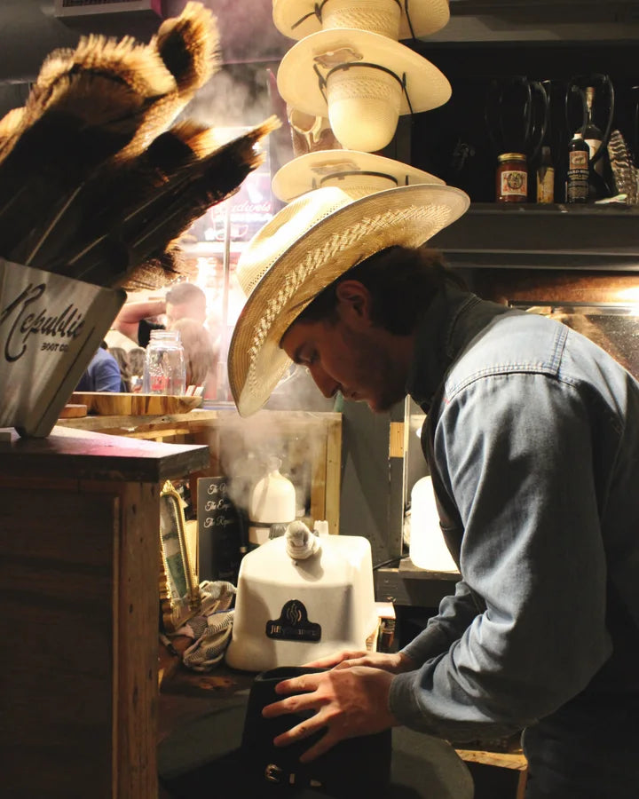 A Republic Hat Bar artisan shaping a hat in the Houston shop