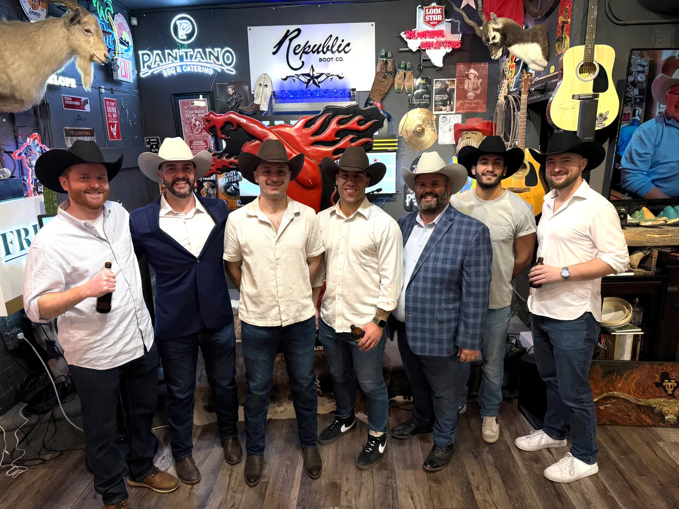 A group wearing their cowboy hats together in the Republic Houston shop