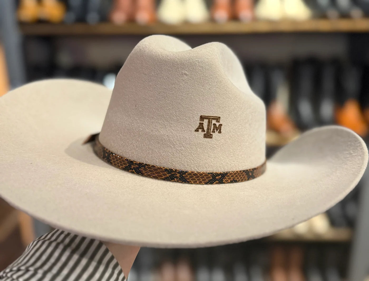 Cream cowboy hat personalized with a Texas A&M brand and patterned hatband